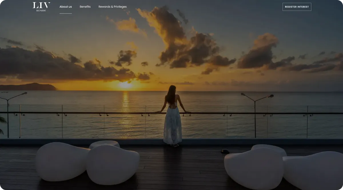 LIV Reside website hero: a woman on a terrace looking out to sea at sunset